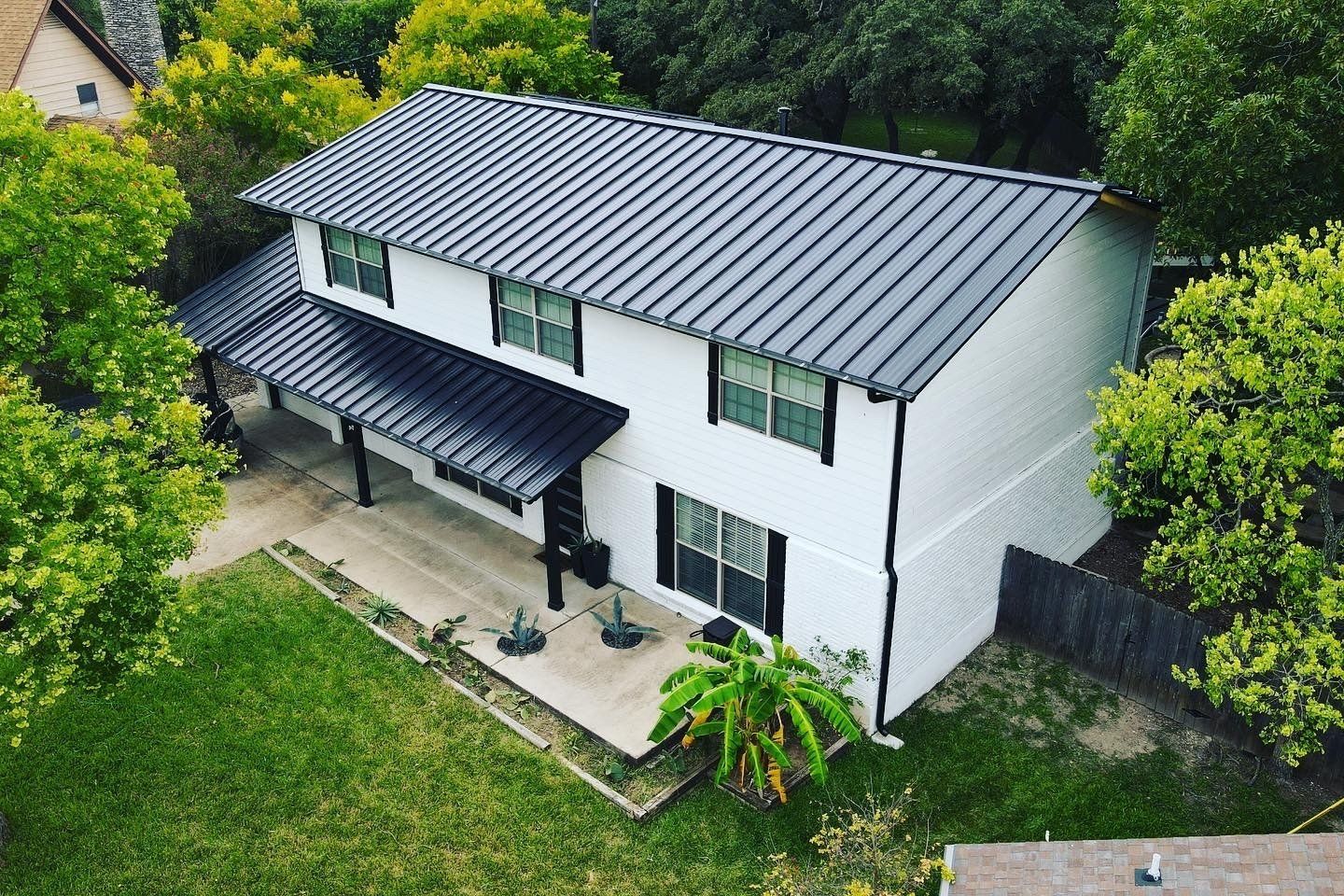 Modern home with dark metal standing seam roof