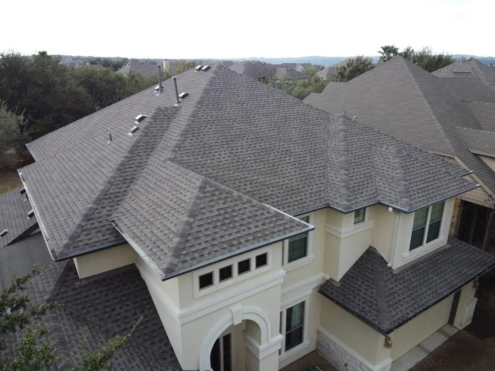Aerial view of residential home with shingle roof